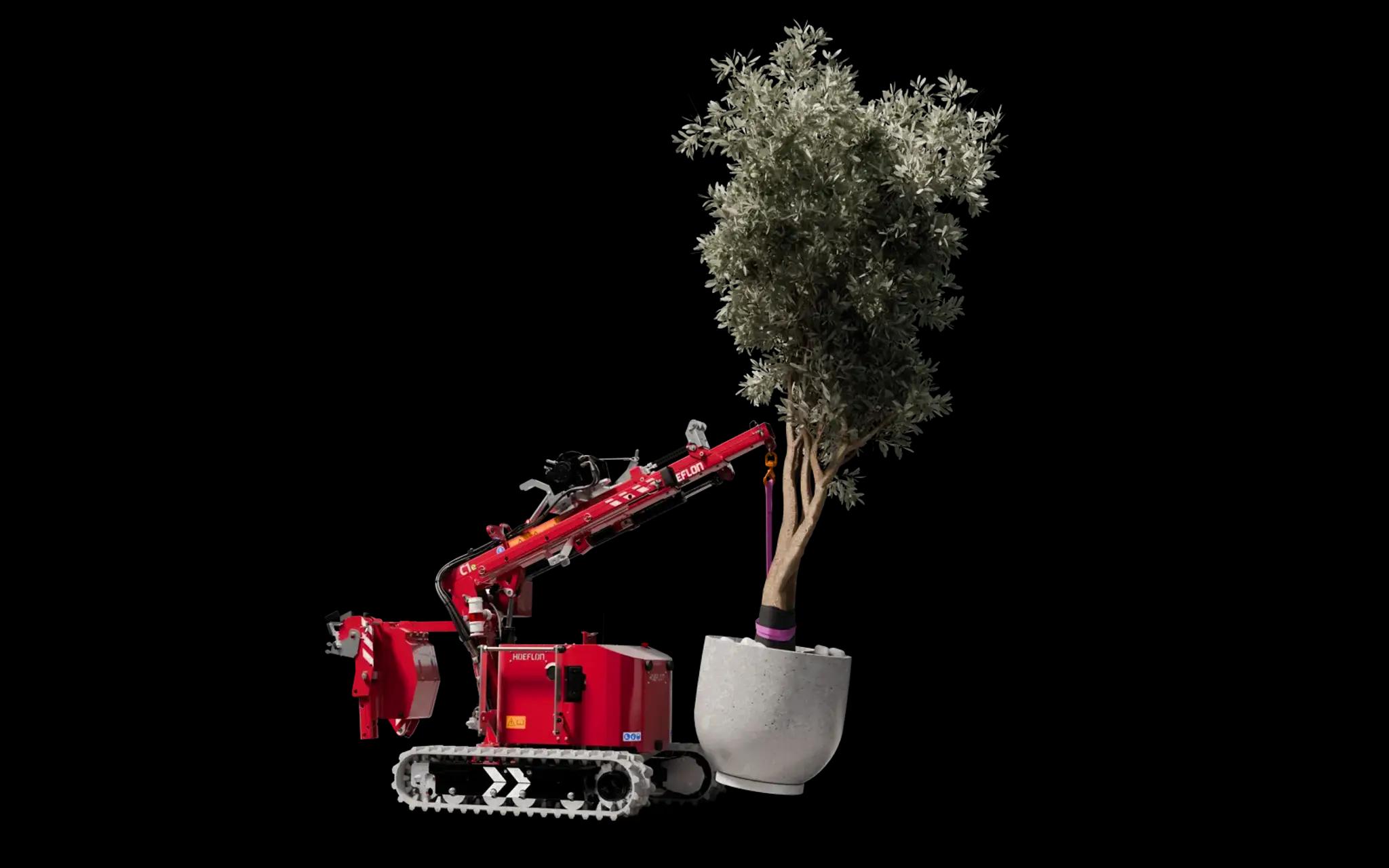 Afbeelding van de Hoeflon C1 kraan in pick-and-carry-modus met een olijfboom.